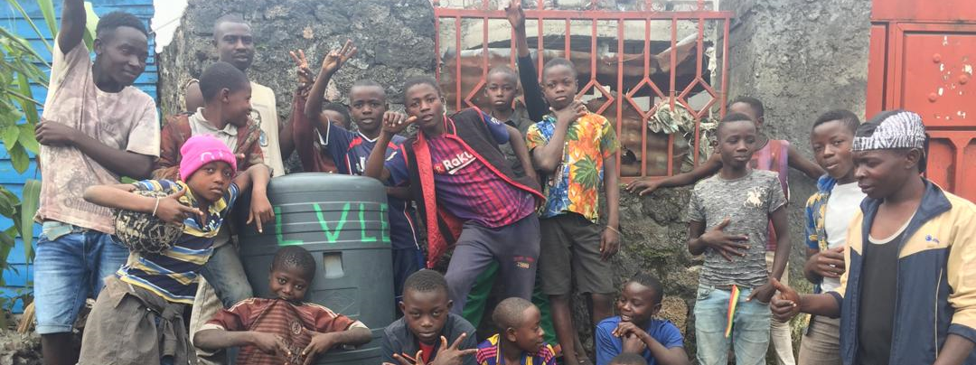 A group of street-living children in DR Congo with a handwashing station
